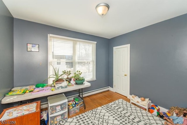 recreation room featuring wood finished floors and baseboards