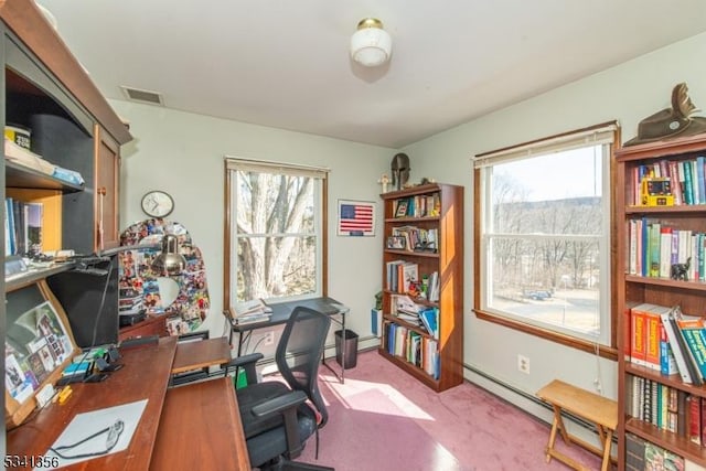 office featuring a wealth of natural light, light colored carpet, visible vents, and baseboard heating