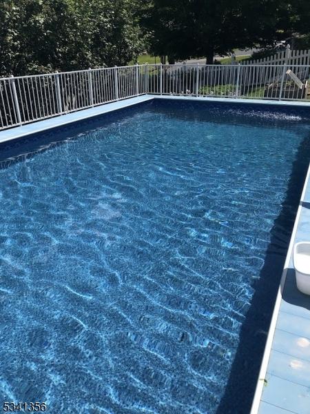 view of swimming pool featuring fence and a fenced in pool