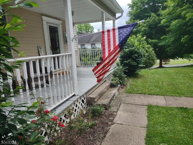 exterior space with a porch and a lawn