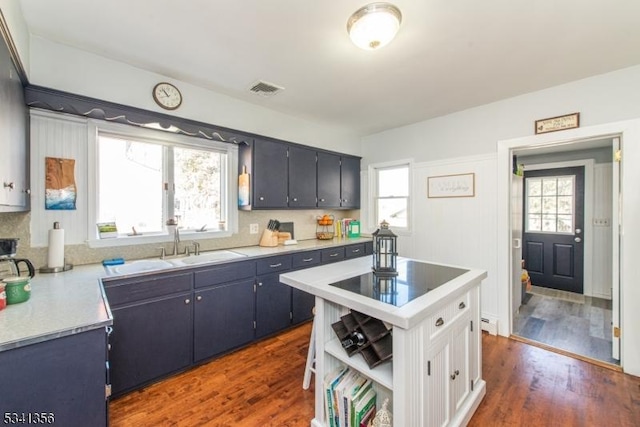 kitchen featuring light countertops, visible vents, open shelves, and wood finished floors