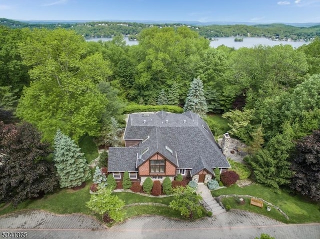 birds eye view of property featuring a water view and a forest view