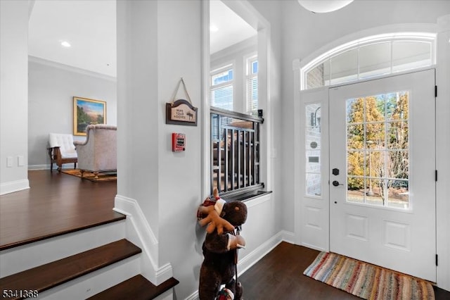 entryway with dark wood-style floors, baseboards, and recessed lighting