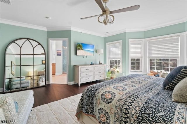 bedroom featuring visible vents, crown molding, baseboards, and wood finished floors