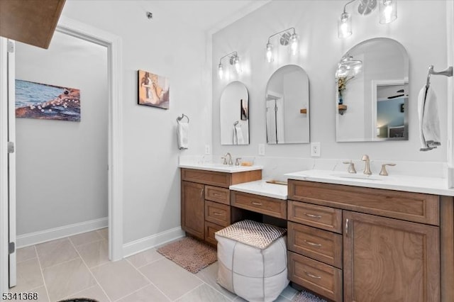 bathroom featuring vanity, baseboards, and tile patterned floors