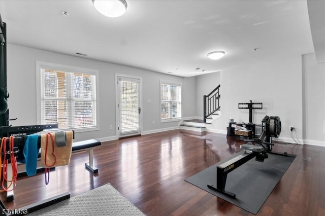 exercise room with visible vents, baseboards, and wood finished floors