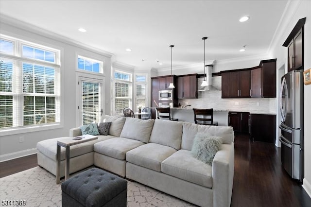 living room featuring ornamental molding, dark wood-type flooring, recessed lighting, and baseboards