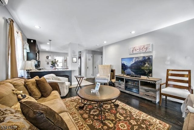 living area with wood finished floors and recessed lighting