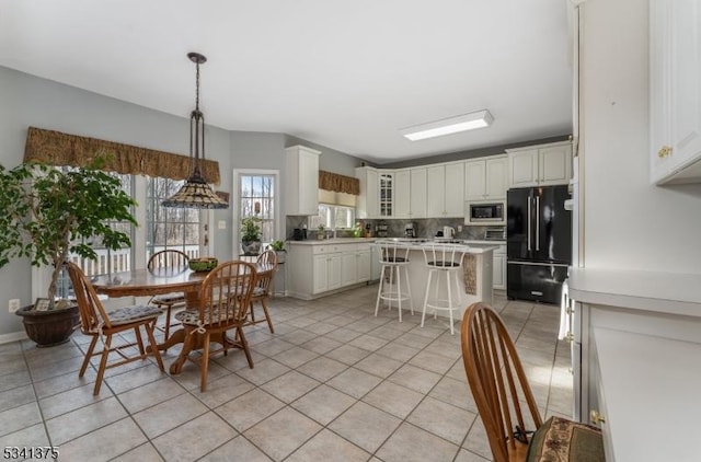 dining area featuring light tile patterned flooring