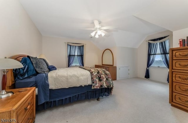 bedroom featuring lofted ceiling, light carpet, and a ceiling fan