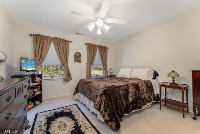 carpeted bedroom featuring visible vents, ceiling fan, and baseboards