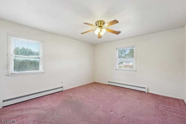 carpeted spare room with ceiling fan and a baseboard radiator