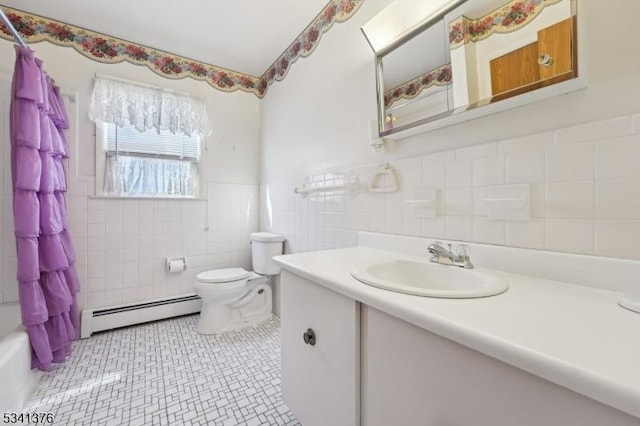 full bathroom with a wainscoted wall, toilet, vanity, tile walls, and a baseboard radiator