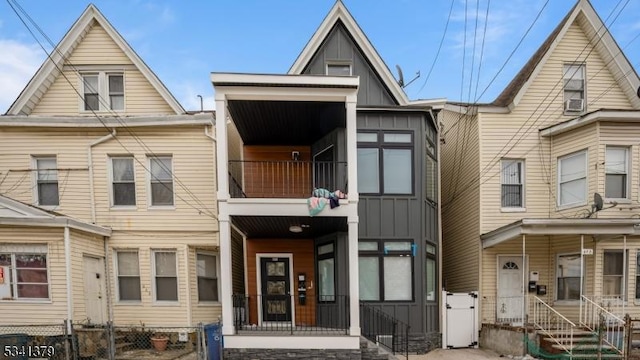 view of property featuring a balcony and board and batten siding