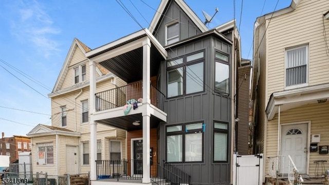 view of front of house featuring board and batten siding, entry steps, and a balcony