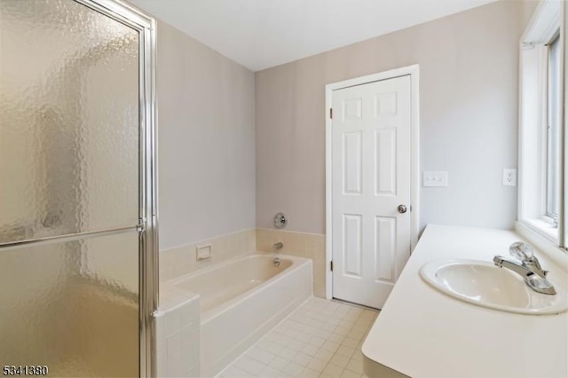 bathroom featuring a wealth of natural light, a shower stall, a bath, and tile patterned floors