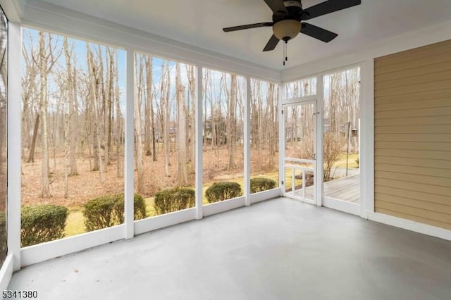 unfurnished sunroom featuring ceiling fan