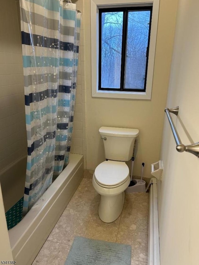 full bathroom with tile patterned flooring, shower / tub combo with curtain, and toilet