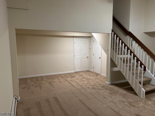 interior space featuring stairway, baseboard heating, carpet, and baseboards