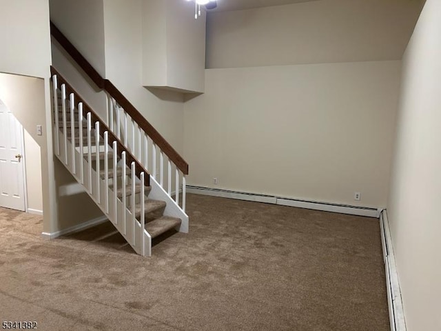 stairway featuring carpet, a baseboard heating unit, and baseboard heating