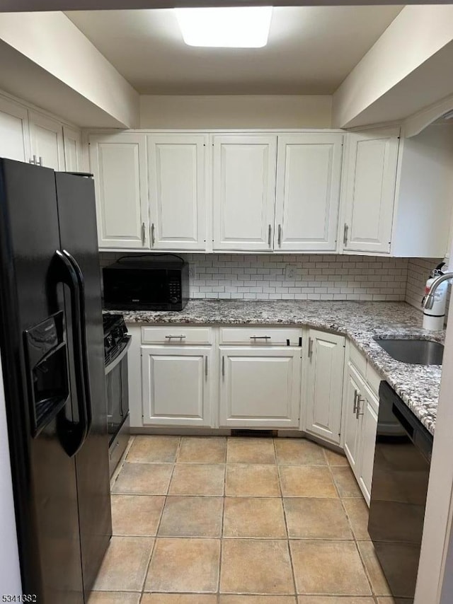 kitchen with black appliances, white cabinetry, backsplash, and a sink