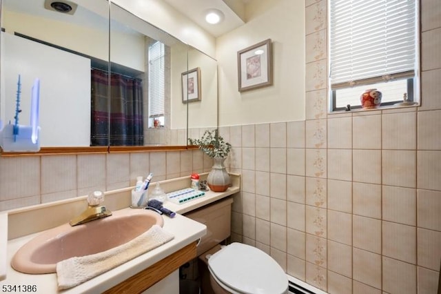 bathroom featuring toilet, vanity, tile walls, and a shower with curtain