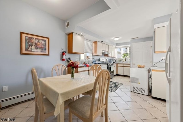 dining area with baseboard heating and light tile patterned floors