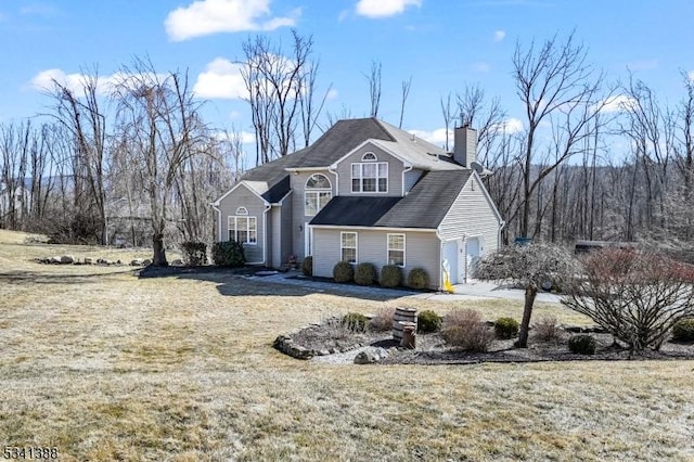 view of front of property featuring a front yard and a chimney