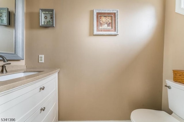 half bath with vanity and toilet