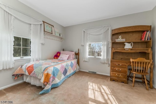 carpeted bedroom featuring baseboards and visible vents