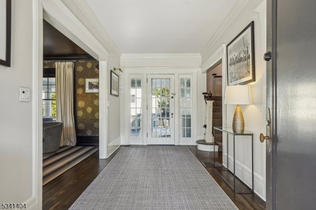 interior space featuring dark wood finished floors, crown molding, and baseboards