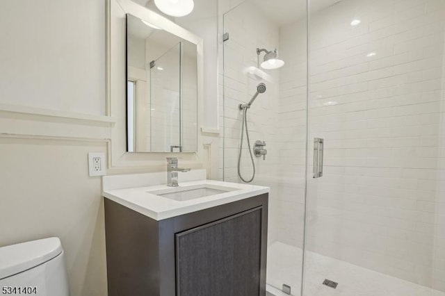 full bathroom with toilet, a stall shower, and vanity