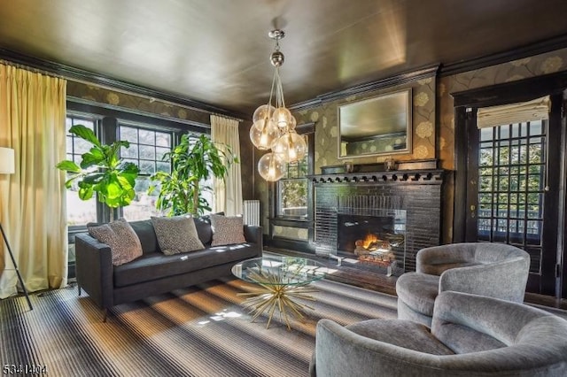 living room with a glass covered fireplace and ornamental molding