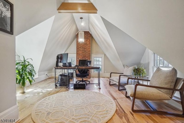 office space featuring vaulted ceiling, wood finished floors, and baseboards