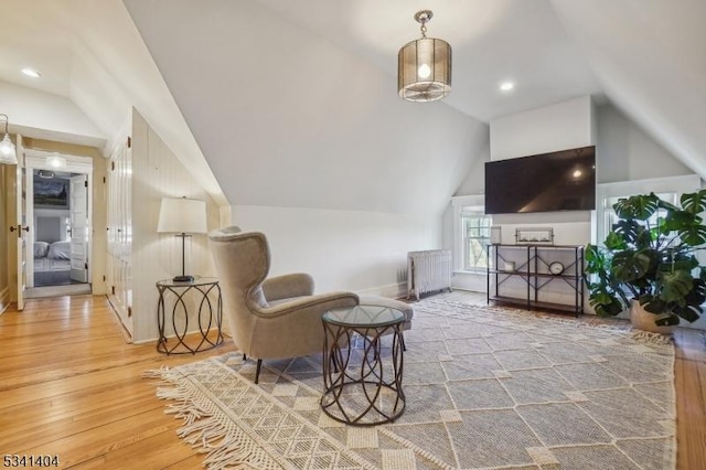 sitting room featuring vaulted ceiling, recessed lighting, and wood-type flooring