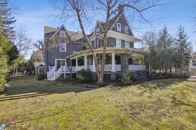 victorian home featuring a porch, a front yard, and a chimney