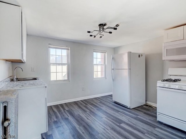 kitchen featuring a sink, light countertops, white appliances, white cabinetry, and dark wood-style flooring