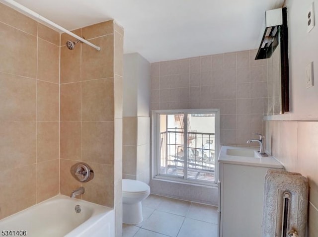 bathroom with tile patterned floors, toilet, vanity, and tile walls