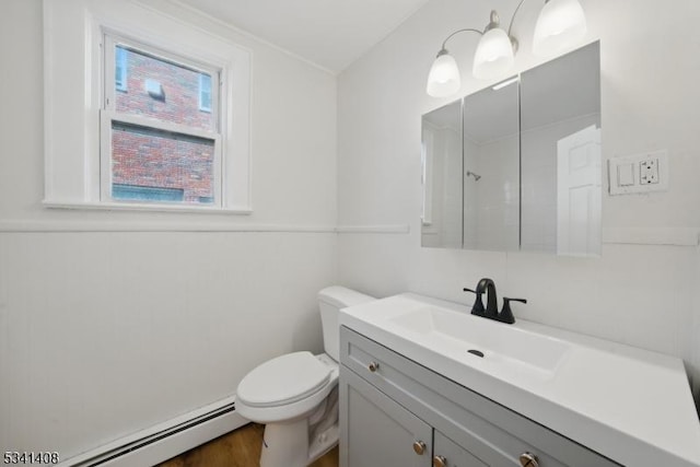 bathroom with a baseboard radiator, vanity, toilet, and wood finished floors