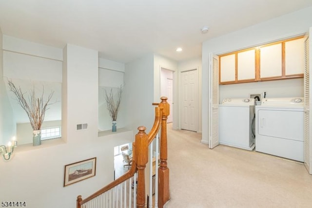 laundry area with recessed lighting, light colored carpet, cabinet space, and separate washer and dryer