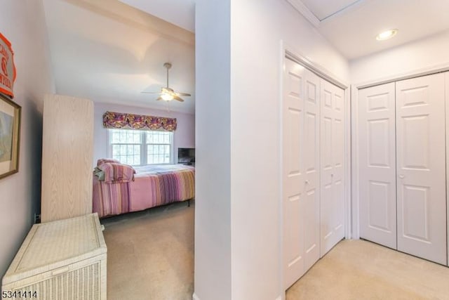 bedroom with a ceiling fan and light carpet