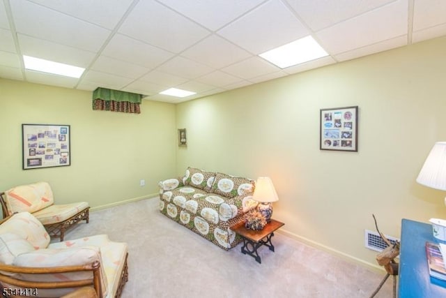 carpeted living room featuring a drop ceiling, visible vents, and baseboards