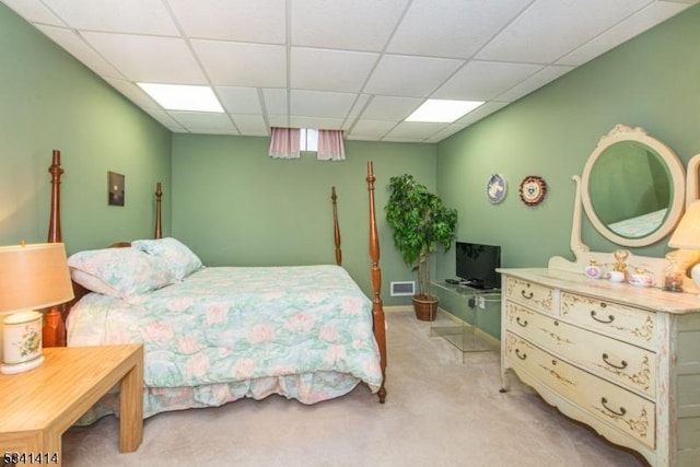 carpeted bedroom with visible vents and a paneled ceiling