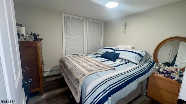 bedroom featuring baseboard heating and wood finished floors