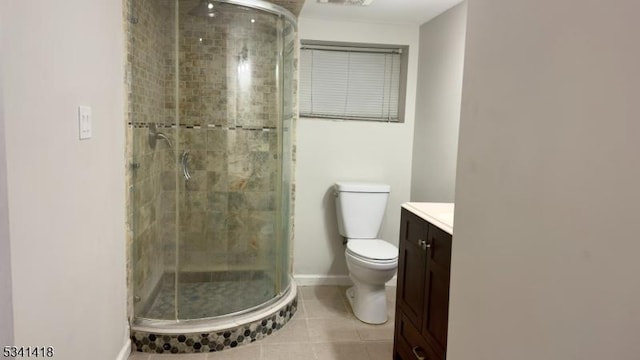 bathroom featuring toilet, vanity, baseboards, a shower stall, and tile patterned floors