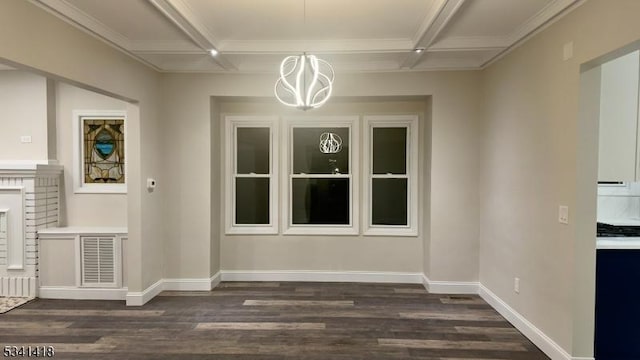 unfurnished dining area featuring baseboards, coffered ceiling, and dark wood-type flooring