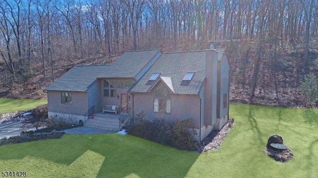 view of front of property featuring a chimney and a front yard