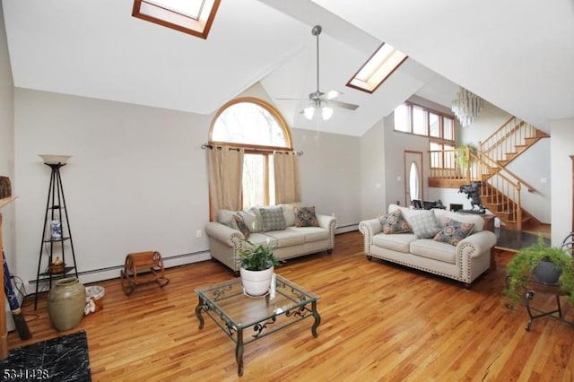 living room with a healthy amount of sunlight, a skylight, and stairway