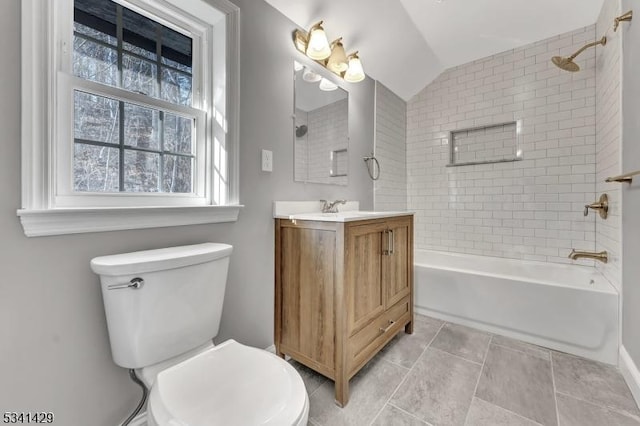 full bathroom featuring tile patterned flooring, toilet, vanity, vaulted ceiling, and shower / washtub combination