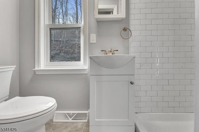 bathroom with toilet, tile patterned flooring, visible vents, and vanity